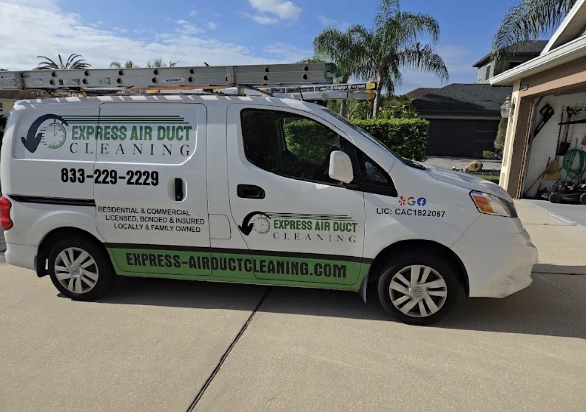 White Express Air Duct Cleaning service van with ladders on the roof, parked in a home driveway